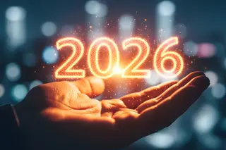 Glowing, sparkling numbers 2026 hovering just above an open hand suggesting this year is your hands